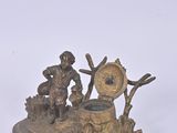 two figurines of a man and a woman sitting on a bench