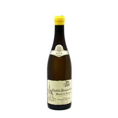 the bottle of wine is sitting on a white surface