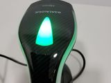 a close up of a computer mouse with a green light on it