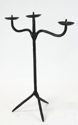 a black metal candelab with three candles on it