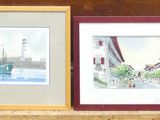 three framed pictures on a shelf next to a red vase
