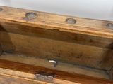 a wooden bench that has a wooden seat on top of it