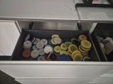 a drawer full of buttons and other things in it