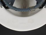 a close up view of a white toilet with a blue seat