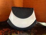 a black and white purse sitting on top of a table