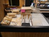 a counter that has many different types of pies on it