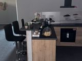 a kitchen with a counter and chairs in it