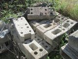 a pile of concrete blocks sitting in the grass