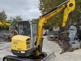 a yellow and black excavator that is parked in a lot