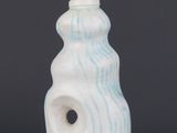 an image of a white and blue ceramic lamp with a light bulb on it