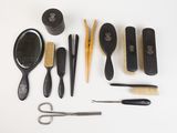 many different types of hair brushes and combs laid out on a table