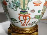 a vase that has a painting on it on a stand
