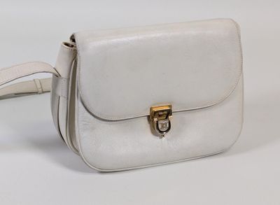 a white purse that is sitting on a white table