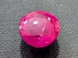 pink gems on a black surface with a white background