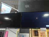 two televisions hanging from the ceiling in a store