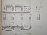 an open book with drawings of a building and a clock tower