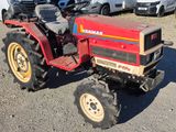 a red tractor that is parked in a parking lot