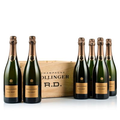 six bottles of champagne in front of a wooden box