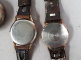 two watches sitting next to each other on a table