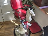 a red chair with a horse head on it in the corner of a room