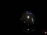 a computer mouse sitting on a black surface in the dark