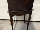 a small wooden table with a small chair on it