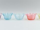 a group of six colorful glass vases sitting on top of a white surface