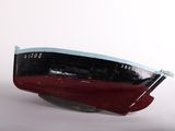 a red and black boat sitting on top of a white surface