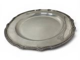a silver plate with a beaded edge on a white background