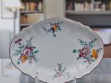 a white plate with flowers on it sitting on a table