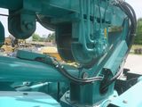 a blue machine that is sitting on the side of the road