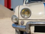 a white car with a blue stripe on the front of it