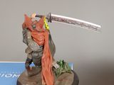 statue of a man holding a sword on top of a box