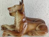 a figurine of a dog laying down on a table