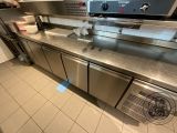 stainless steel counter top in a commercial kitchen with stainless steel appliances