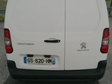 a white van that is parked in a parking lot