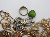 many different types of jewelry on a white surface