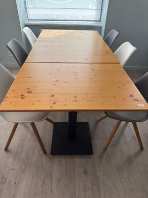 a long table with many chairs around it in a room