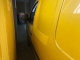 two yellow trucks parked side by side in a garage