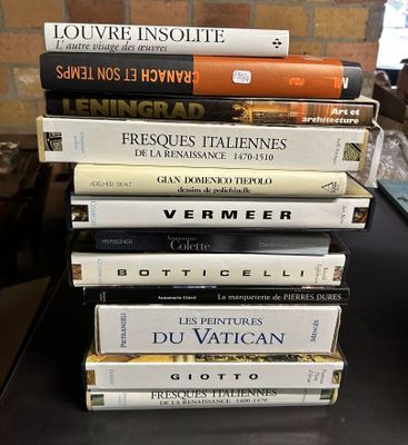 many books stacked on top of each other on a table