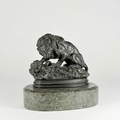 statue of a lion on a stone base with a white background