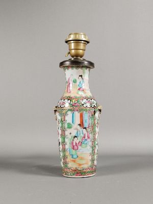 un petit vase orné d'un couvercle doré, posé sur une table