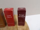 two boxes of love cherry and cherry berry on a wooden table