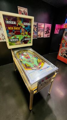 a pinball machine and a pinball machine in a room