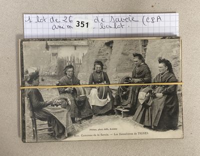an old photo of a group of people sitting around a table