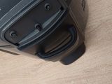 a black suitcase sitting on a wooden floor