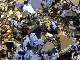 a pile of silver and black crystals on a table
