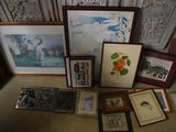 many framed pictures on the floor of this room