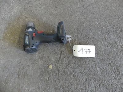 a cordless drill on the ground with a price tag