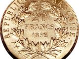 a close up of a gold coin with a wreath on it